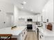 Contemporary kitchen with stainless steel appliances, white cabinets and a large island at 9855 S 47Th Pl, Phoenix, AZ 85044