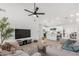 Open-concept living room flowing into the kitchen with modern furnishings and ample natural light at 9855 S 47Th Pl, Phoenix, AZ 85044