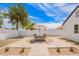 Backyard patio with outdoor seating, desert landscaping, and a privacy wall at 9855 S 47Th Pl, Phoenix, AZ 85044