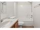 A bathroom features tile flooring, tub and shower combo, and vanity with sink at 11139 W Devonshire Ave, Phoenix, AZ 85037