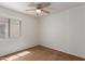 Clean bedroom with soft carpet, bright neutral walls, a ceiling fan, and window for lots of light at 11139 W Devonshire Ave, Phoenix, AZ 85037