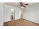 Bedroom featuring carpet, a ceiling fan and two doorways, one leading to an ensuite bathroom at 11139 W Devonshire Ave, Phoenix, AZ 85037