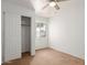Bedroom with neutral walls, soft carpet, ceiling fan, and large closet with open doors for extra storage at 11139 W Devonshire Ave, Phoenix, AZ 85037