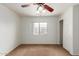 Cozy bedroom with a ceiling fan, plush carpet, a closet and natural light from the window at 11139 W Devonshire Ave, Phoenix, AZ 85037