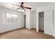 Bright bedroom with neutral walls, carpet flooring, ceiling fan and spacious double door closets at 11139 W Devonshire Ave, Phoenix, AZ 85037