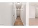 Hallway with tile flooring, neutral wall color and multiple closets/doorways leading into other rooms at 11139 W Devonshire Ave, Phoenix, AZ 85037