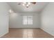 Bright living room featuring tile floors, a ceiling fan, and neutral wall paint at 11139 W Devonshire Ave, Phoenix, AZ 85037