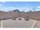 Private backyard featuring a charming fire pit area with Adirondack chairs, ideal for relaxation and entertaining at 11159 E Sebring Ave, Mesa, AZ 85212