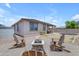Spacious backyard featuring a gravel area with a fire pit and Adirondack chairs, perfect for outdoor gatherings at 11159 E Sebring Ave, Mesa, AZ 85212