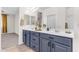 Spacious bathroom with double sinks, vanity with drawers, decorative mirrors, and neutral wall color at 11159 E Sebring Ave, Mesa, AZ 85212