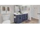 Stylish bathroom featuring a double sink vanity with blue cabinetry and modern fixtures at 11159 E Sebring Ave, Mesa, AZ 85212
