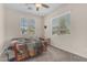 Bedroom with natural light from dual windows, ceiling fan, and cozy quilt on a comfortable bed at 11159 E Sebring Ave, Mesa, AZ 85212