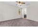Bright bedroom with a ceiling fan, carpeted floor, and a bathroom attached at 11159 E Sebring Ave, Mesa, AZ 85212