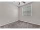 This is a simple bedroom with carpet, white walls, and a ceiling fan at 11159 E Sebring Ave, Mesa, AZ 85212