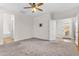 The bedroom features a ceiling fan, carpeted floor, bathroom access, and backyard patio entrance at 11159 E Sebring Ave, Mesa, AZ 85212