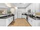 Bright kitchen featuring white cabinetry, dark countertops, and stainless steel appliances at 11159 E Sebring Ave, Mesa, AZ 85212