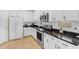 Well-equipped kitchen with stainless steel appliances, sleek countertops, and white cabinets at 11159 E Sebring Ave, Mesa, AZ 85212