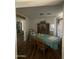 Traditional dining room with wood floors and a dining table covered with a blue tablecloth at 11640 N 74Th Dr, Peoria, AZ 85345