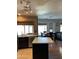 Open kitchen layout with tiled backsplash and island and view to the dining room at 11640 N 74Th Dr, Peoria, AZ 85345