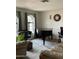 Living room featuring natural light, elegant piano, with modern furniture and decor at 11640 N 74Th Dr, Peoria, AZ 85345