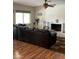 Cozy living room featuring a fireplace, ceiling fan, and hardwood floors at 11640 N 74Th Dr, Peoria, AZ 85345