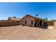 Great view of the backyard, featuring the home, covered patio and block wall at 15231 W Melissa Ln, Surprise, AZ 85374