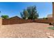 Large backyard with brick wall for added privacy, a mix of trees and shade at 15231 W Melissa Ln, Surprise, AZ 85374