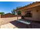 Cozy backyard with barbecue, table, covered patio with backyard privacy wall at 15231 W Melissa Ln, Surprise, AZ 85374