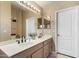 Bathroom vanity with double sinks, large mirror and ample lighting, perfect for a busy morning routine at 15231 W Melissa Ln, Surprise, AZ 85374