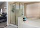 Bright bathroom featuring a bathtub and shower combination with frosted glass door at 15231 W Melissa Ln, Surprise, AZ 85374