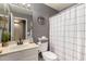 This modern bathroom features a neutral color scheme, sleek vanity, and updated shower-tub combo at 15231 W Melissa Ln, Surprise, AZ 85374