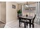 Cozy dining area with four-seater table and a modern light fixture at 15231 W Melissa Ln, Surprise, AZ 85374