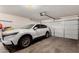 Spacious two-car garage featuring a new car and room for storage at 15231 W Melissa Ln, Surprise, AZ 85374