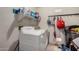 This utility room includes a washer and dryer with extra storage, plus some wall hooks at 15231 W Melissa Ln, Surprise, AZ 85374