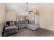 A cozy living room with a comfortable gray sectional sofa offers a relaxing space at 15231 W Melissa Ln, Surprise, AZ 85374