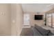 Cozy living area with neutral paint, tiled entry, carpeted floor, and a sliding glass door to patio at 15231 W Melissa Ln, Surprise, AZ 85374