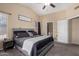 Spacious main bedroom with a comfortable bed, ceiling fan, neutral paint, vaulted ceilings, and an attached bathroom at 15231 W Melissa Ln, Surprise, AZ 85374