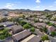 Sprawling neighborhood featuring desert landscaping, tile roofs, and mountain views, emphasizing a suburban community at 154 W Hayden Park Rd, San Tan Valley, AZ 85143