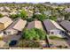 A high angle view of a backyard, enclosed by a block wall, with mature landscaping at 154 W Hayden Park Rd, San Tan Valley, AZ 85143