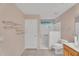 Well-lit bathroom featuring tiled shower and grab bars at 154 W Hayden Park Rd, San Tan Valley, AZ 85143