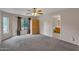 Bedroom featuring neutral carpet, ceiling fan, and view to ensuite bathroom at 154 W Hayden Park Rd, San Tan Valley, AZ 85143