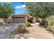 Charming single-story home featuring a two-car garage, desert landscaping, and a beautiful blue sky at 154 W Hayden Park Rd, San Tan Valley, AZ 85143
