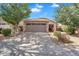Charming single-story home featuring a two-car garage, desert landscaping, and a beautiful blue sky at 154 W Hayden Park Rd, San Tan Valley, AZ 85143