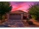 Charming single-story home featuring a two-car garage, desert landscaping, and a beautiful sunset sky at 154 W Hayden Park Rd, San Tan Valley, AZ 85143