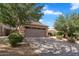 Charming single-story home featuring a two-car garage, desert landscaping, and a beautiful blue sky at 154 W Hayden Park Rd, San Tan Valley, AZ 85143