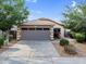 Charming home featuring a well-maintained yard, desert landscaping, and a spacious driveway leading to a two-car garage at 154 W Hayden Park Rd, San Tan Valley, AZ 85143