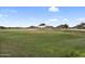 Expansive golf course view with rolling green, mountain backdrop, and clear blue sky, creating a sense of openness at 154 W Hayden Park Rd, San Tan Valley, AZ 85143