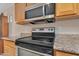 Close-up of an oven, microwave, and countertops in a well-maintained kitchen at 154 W Hayden Park Rd, San Tan Valley, AZ 85143