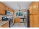 Well-lit kitchen with stainless steel appliances, oak cabinets, and tile flooring at 154 W Hayden Park Rd, San Tan Valley, AZ 85143