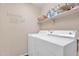 Bright laundry room with washer, dryer, and storage shelving at 154 W Hayden Park Rd, San Tan Valley, AZ 85143